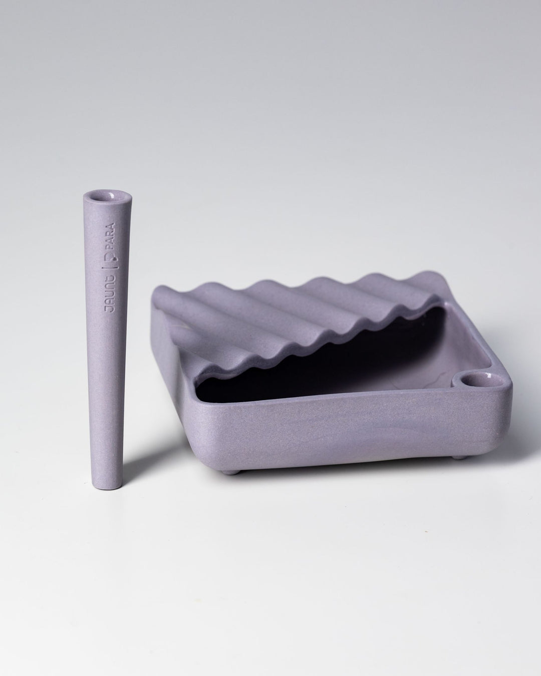 Lidded ceramic ashtray with half lid, corner joint snuffer, and matching ceramic one-hitter.