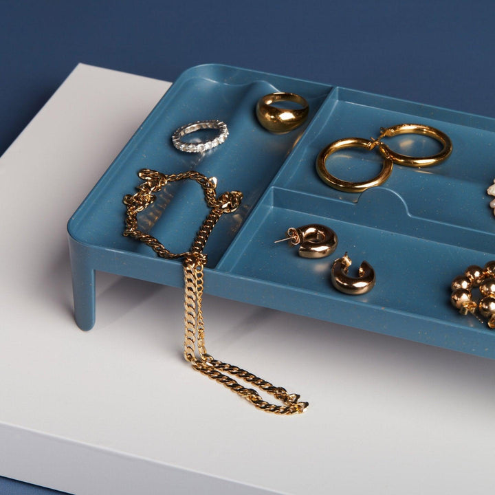 Navy blue weed lockbox used as jewelry catchall tray.