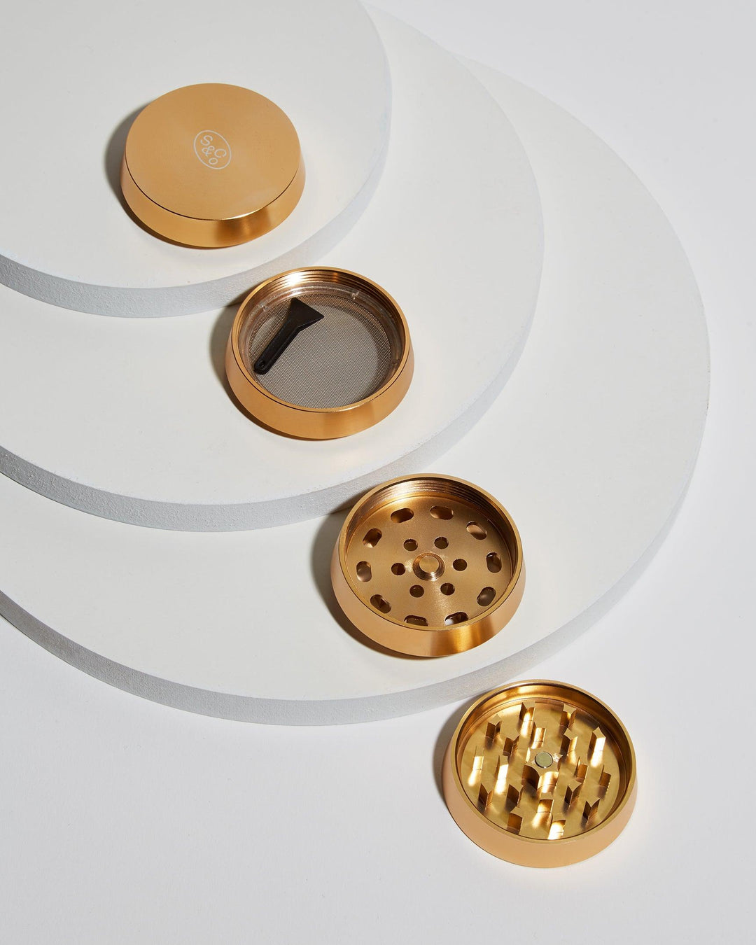 four individual components gold metal grinder