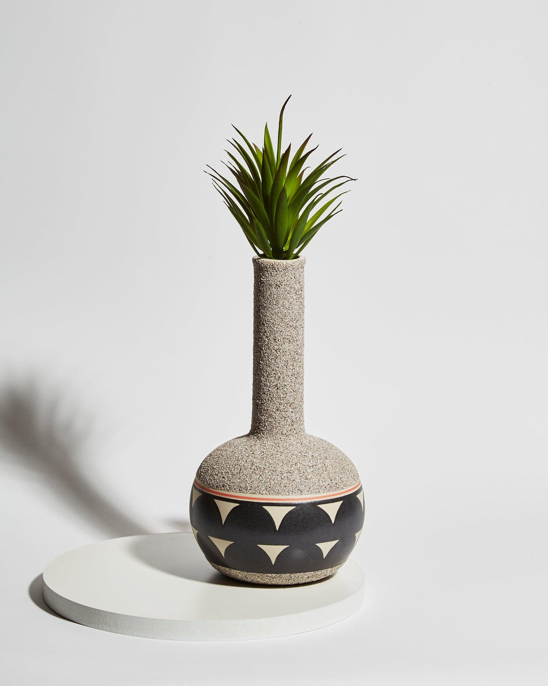 floral arrangement inside ceramic vase bong