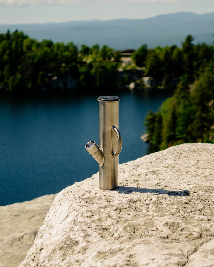 outdoor titanium dangle supply bong on mountain with lake background