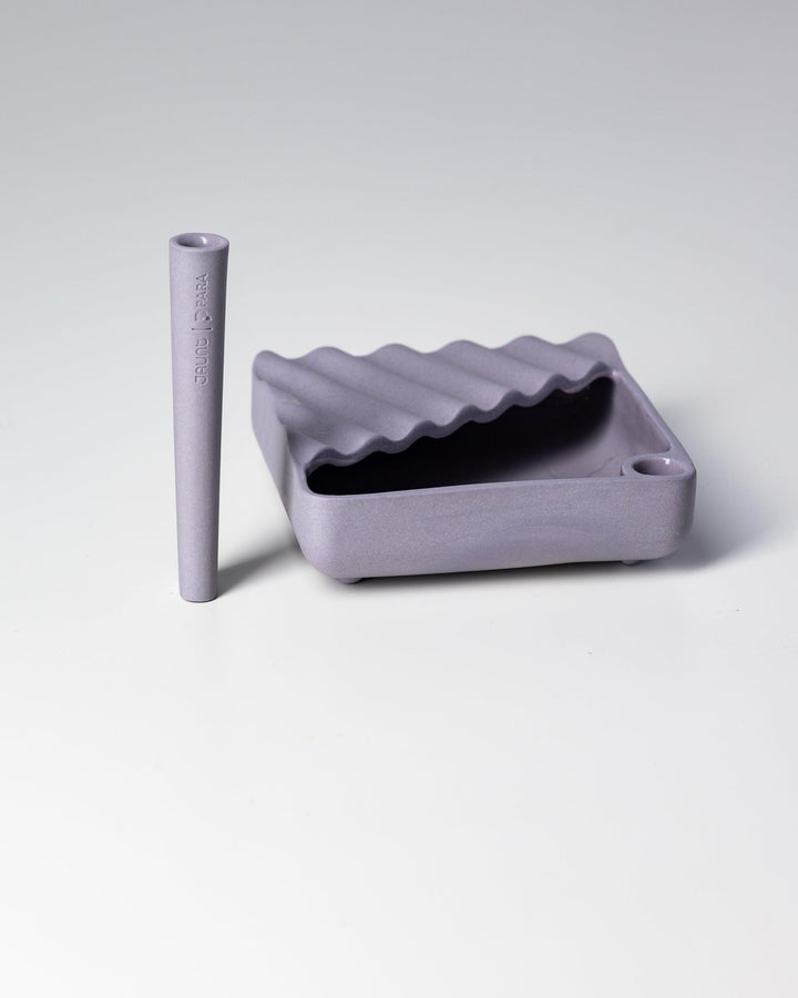 Lavender ceramic ashtray with matching lavender one-hitter.