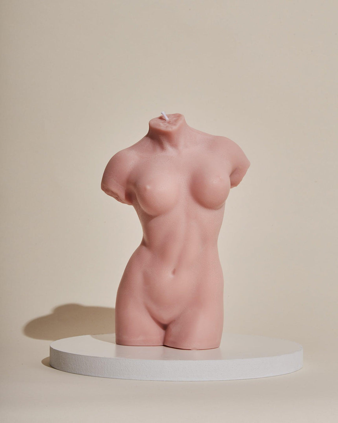 pink female body sculpture candle