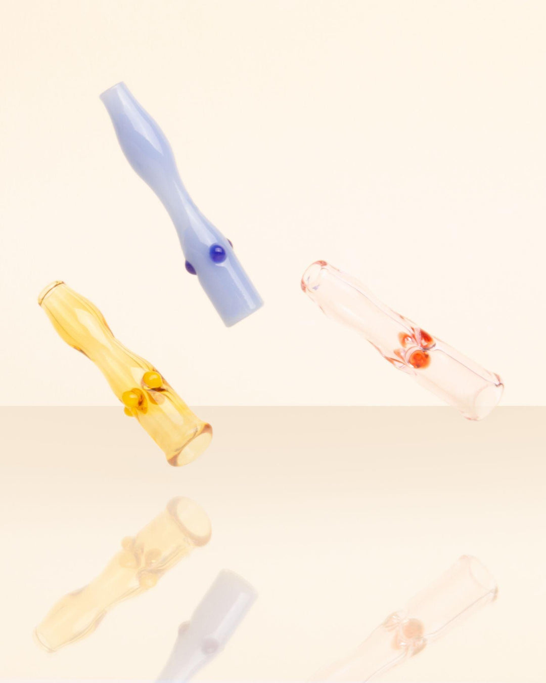 Colorful glass joint holders in purple yellow and pink by luxury brand House of Puff. 