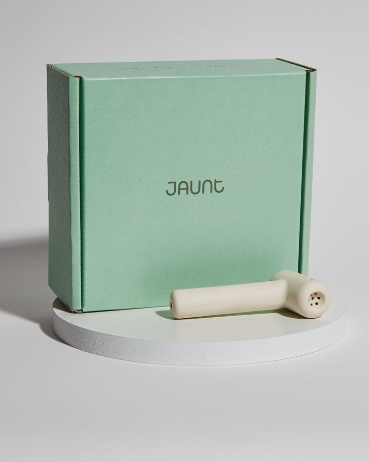 Small white ceramic pipe with Jaunt packaging.