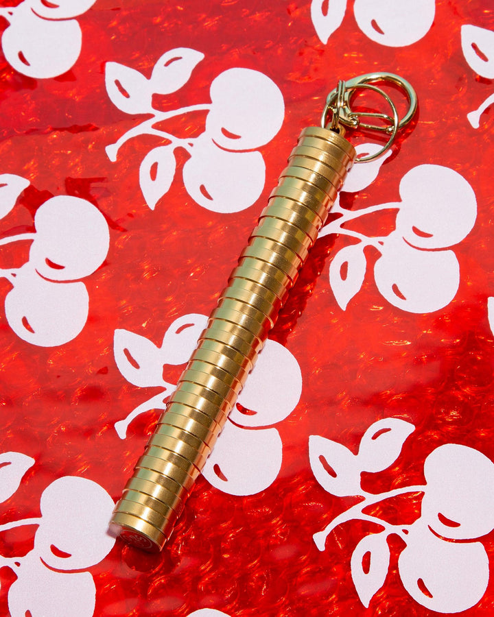 gold keychain joint carrier with red bubble stash bag
